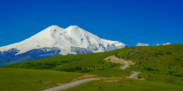 istock Panorama Road Leading at Hills to Mount Elbrus 1257578087
