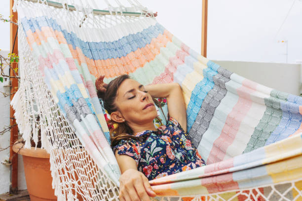 istock Relaxed woman, napping on hammock. Relaxing tranquility on summer vacation 1257578306