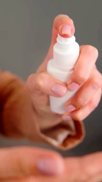 istock the hands of a woman who is using a spray 1257579092