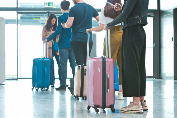 istock Passengers waiting in line at airport terminal 1257579094
