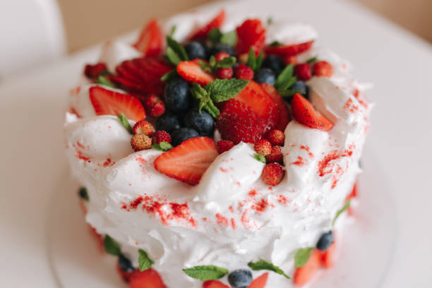 istock Delicious strawberry birthday cake on white table. Cake decorated with blueberry and mint. Vegetarian food. Lactose free and gluten free 1257581384