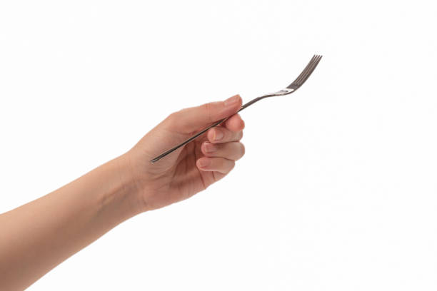 istock Fork in woman hand isolated on white. 1257581439