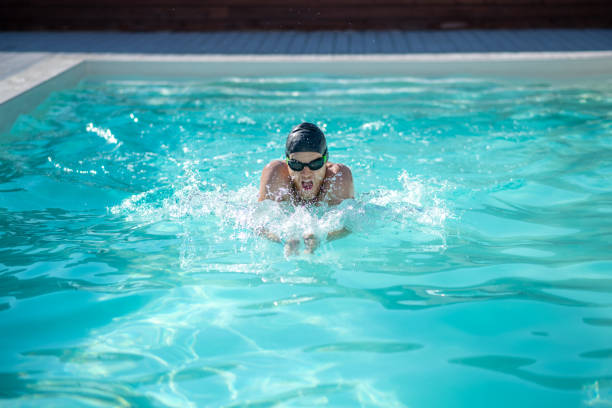 istock Swimmer in pool head above water hands in front 1257581986