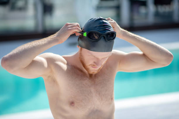 istock Man in swimming cap wearing swimming goggles. 1257582087