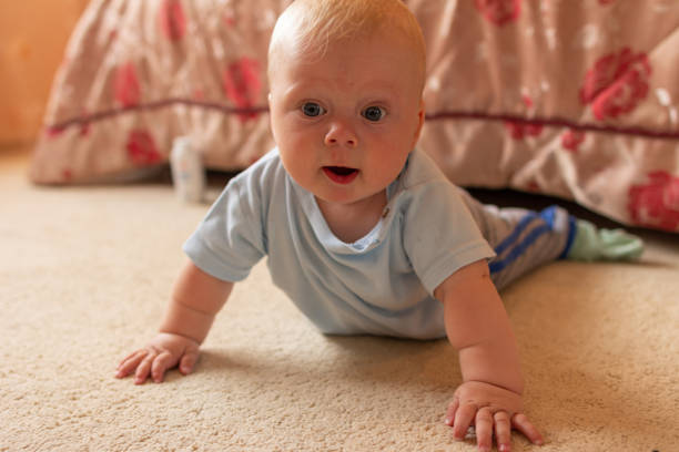 istock baby boy on the floor 1257583690