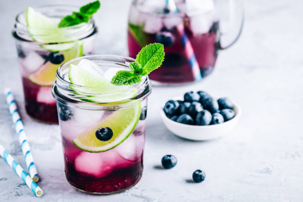 Blueberry and lime mojito or lemonade. Refreshing summer drink Blueberry and lime mojito or lemonade. Refreshing summer drink with berry and ice. mason jar lemonade stock pictures, royalty-free photos & images