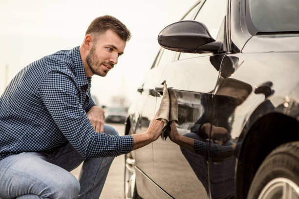 istock Young man polishing his car 1257585218