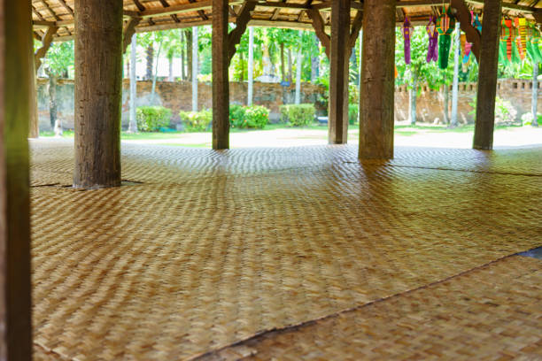 Many mats laid in a wooden pavilion for sitting and resting