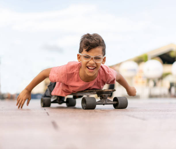 istock Child lying on skateboard playing in the street 1257593154