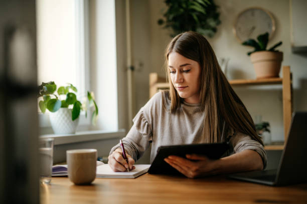 istock Young female adult working from home 1257594759