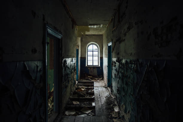 istock Dark creepy corridor of abandoned building 1257596331