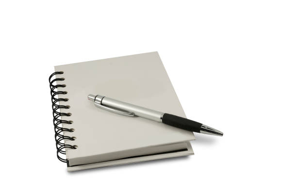 istock Blank notebook with pen and pencil isolated on white background. 1257597569