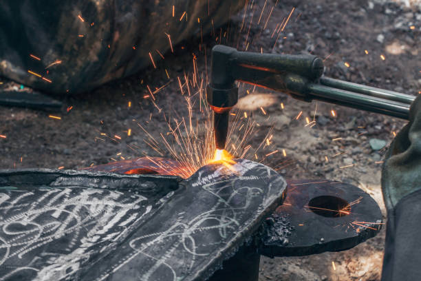 istock Close up hand heavy industrial worker is working on metal work factory process by Cutting sheet steel with gas cutting machine cutting thick steel in boilermakers workshop. 1257599355