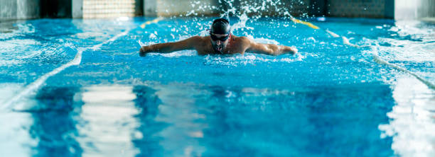 istock professional swimmer doing exercise in indoor swimming pool 1257599428