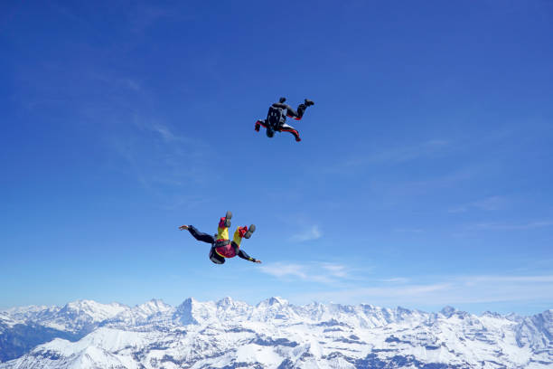 istock Freefall flier descend through lofty skies above mountain landscape 1257600341