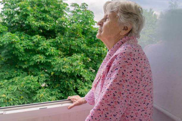 istock Senior woman in her home balcony looking at trees 1257600954