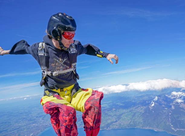 istock Freefall flier descend through lofty skies above mountain landscape 1257601065