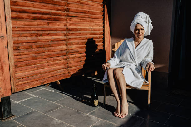 istock Young woman wearing bathrobe relaxing on the balcony 1257601254