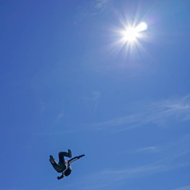 istock Freefall flier descend through lofty skies above mountain landscape 1257601331
