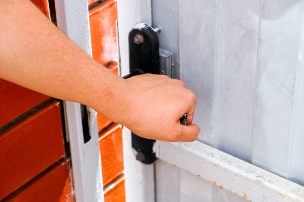 istock Womans hand opening door outside. 1257602128