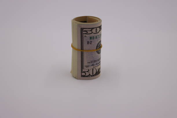 istock Money. Roll of dollars on white background 1257602147