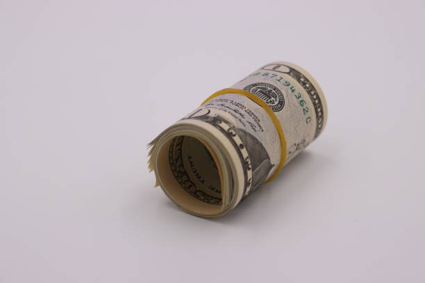 istock Money. Roll of dollars on white background 1257602184