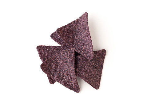 Isolated on white background organic blue corn tortilla chips with clipping path.