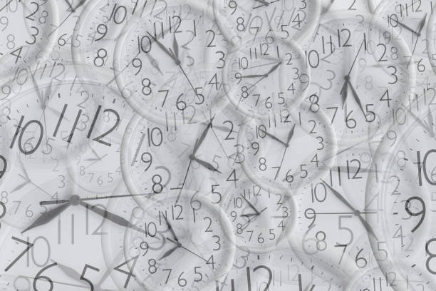 istock Background from set of white analog round office clocks of different sizes showing various time 1257602954