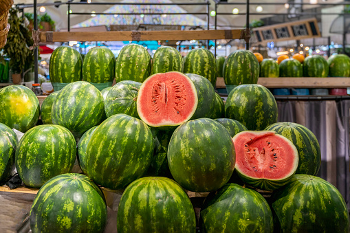 Many watermelon is sold in the fruit market.