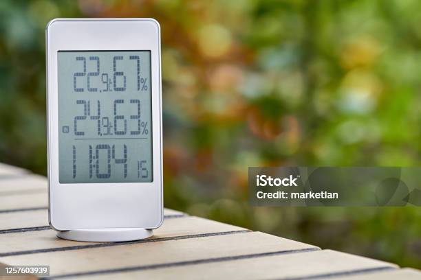 Best Personal Weather Station Device With Weather Conditions Inside And Outside On Foliage Background Home Digital Weather Forecast Concept With Temperature And Humidity Stock Photo - Download Image Now