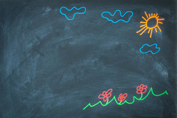 Colored chalk drawing on blackboard for back to school concept. Top view of chalkboard with sun, clouds, flowers, ar grass drawing. Hand drawn picture on blackboard for banner design