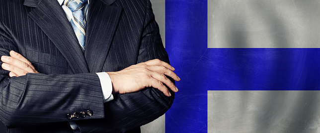 Male hands against Finnish flag background, business, politics and education in Finland concept