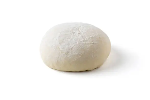 Raw pizza or bread dough proofing and rising on white background with clipping path.