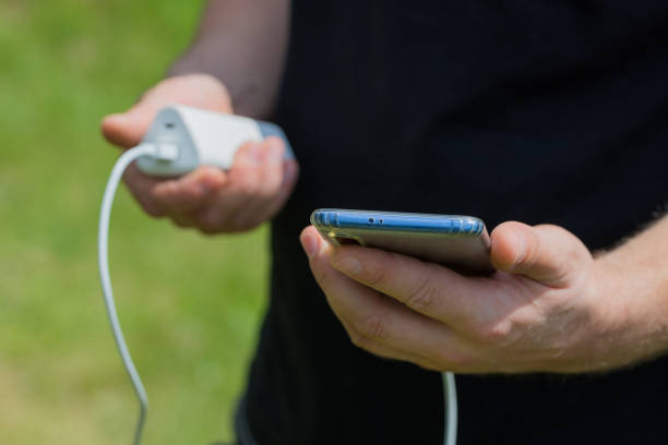 istock a Young man charges the phone using a power bank outside 1257608880