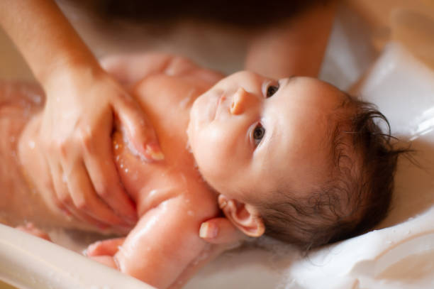 istock baby in the bath. 1257609035