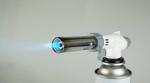 istock Gas burner with blue fire flame at gray background 1257610236