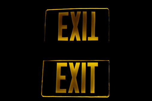 Yellow Exit Sign Reflection on Black
