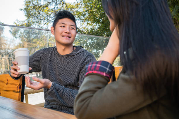 istock Asian couple at coffee shop. 1257611678