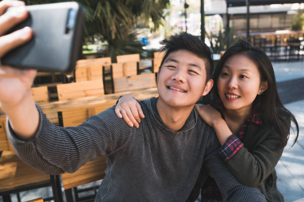 istock Asian couple taking a selfie with mobile phone. 1257611684