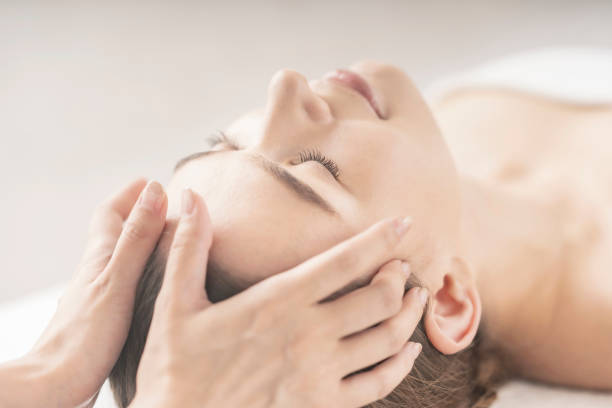 istock Young woman having her head massaged 1257611748