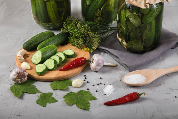 istock Fermented cucumbers in glass jars on a concrete background. 1257614452
