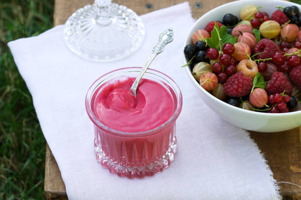 delicious vanilla pudding trifle with raspberries, with baiser, decorated with lemon balm