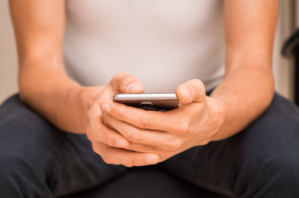 istock Close up. Male hands are holding a smartphone. 1257614984