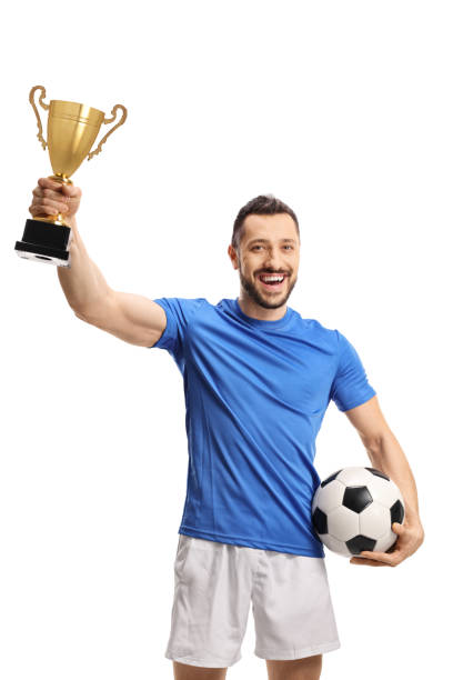 Soccer player holding a ball and a golden trophy cup