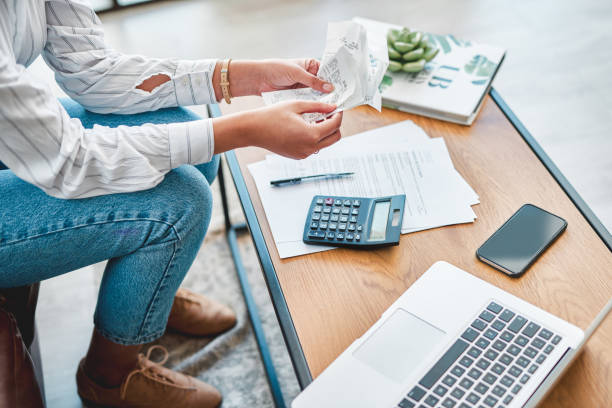 Is telecommuting costing you more? Cropped shot of a woman going through her finances at home debt photos stock pictures, royalty-free photos & images