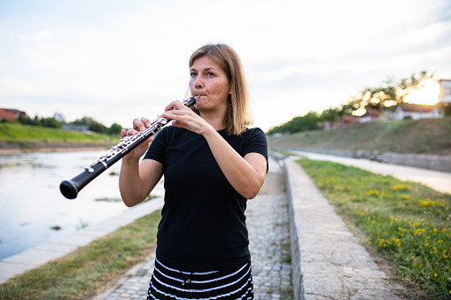 Female hands hold clarinet, isolated on white background