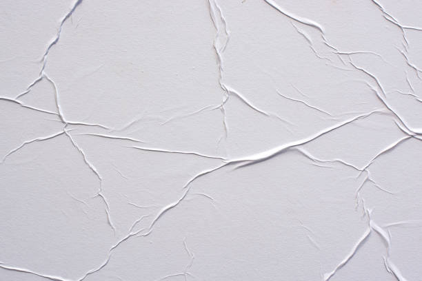 istock White crumpled paper close-up. Abstract background for design. 1257627227