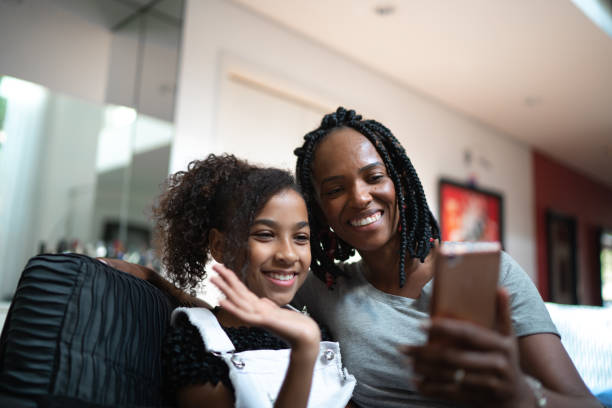 istock Mother and daughter doing a video call at home 1257628217