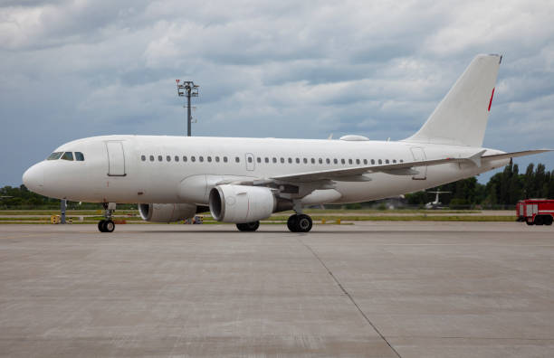 istock Passenger white plane at the airport. Place for text. Clouds sky 1257628685