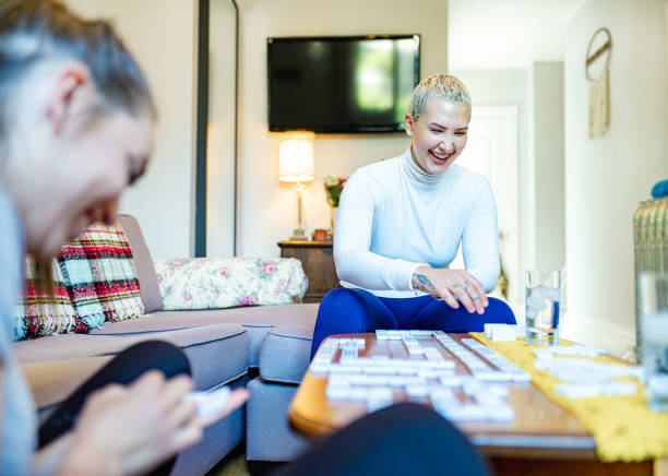 istock Young women playing domino 1257631649
